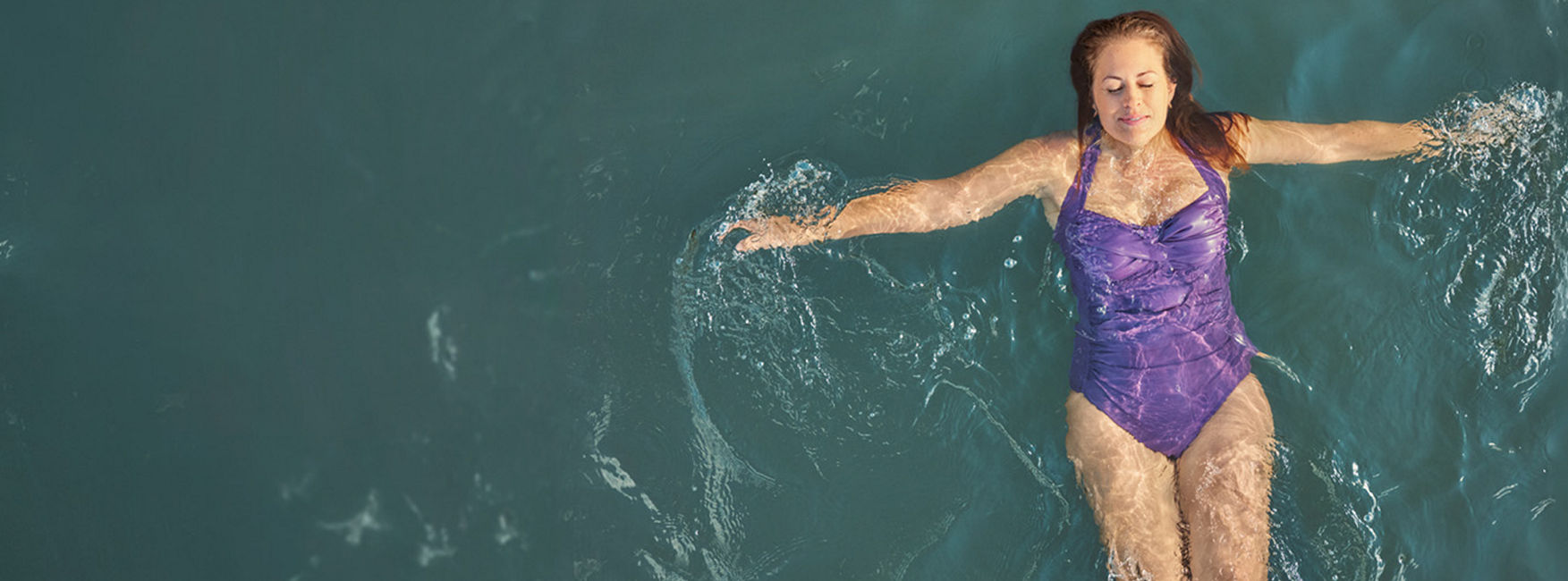 Woman floating in ocean